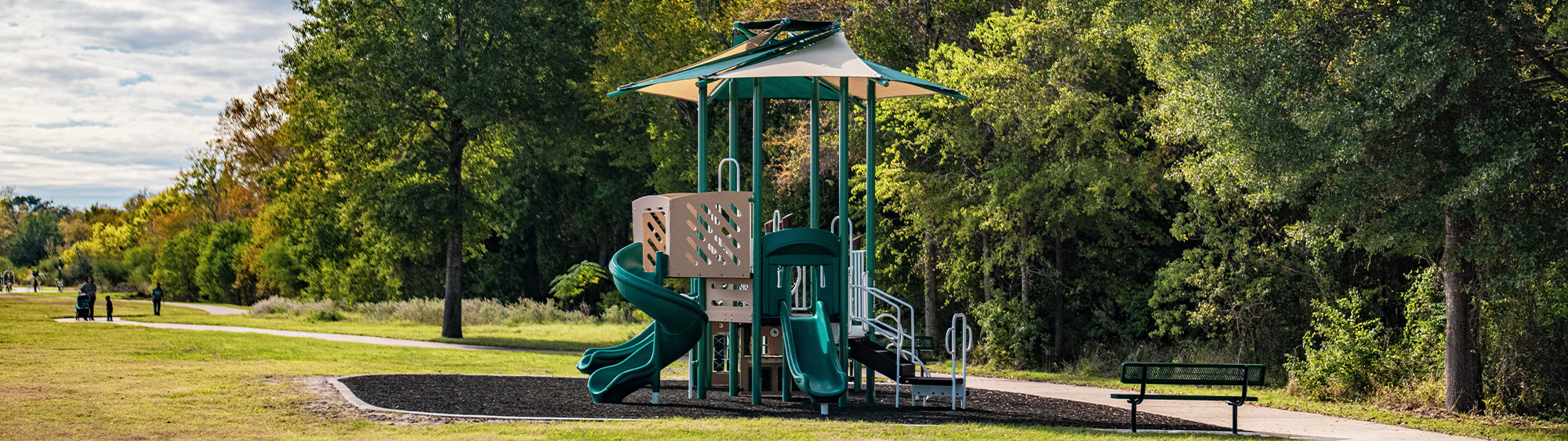 Playground and trail shown at Greenbrier Park.