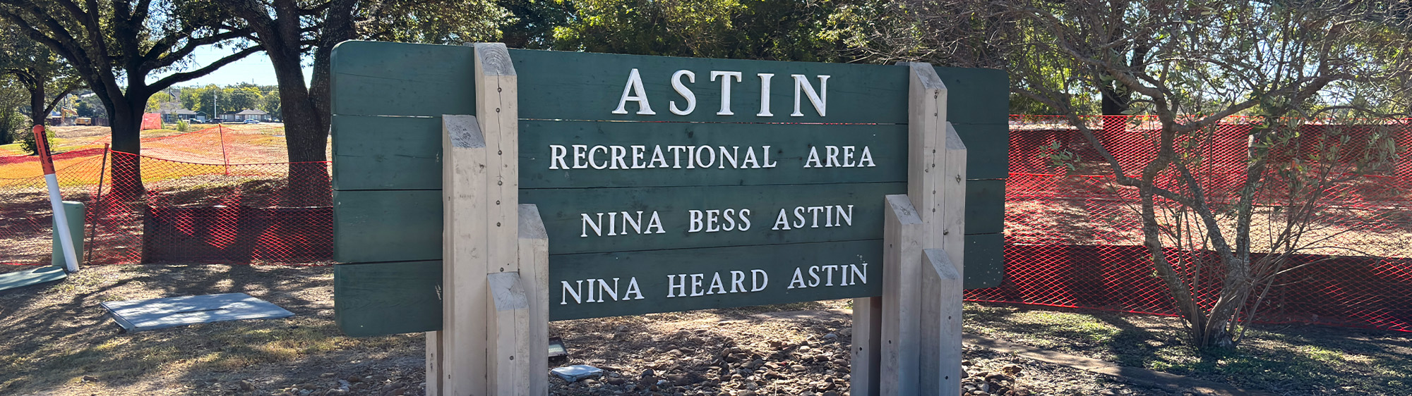 Astin Recreational Area sign with orange construction fencing behind it.