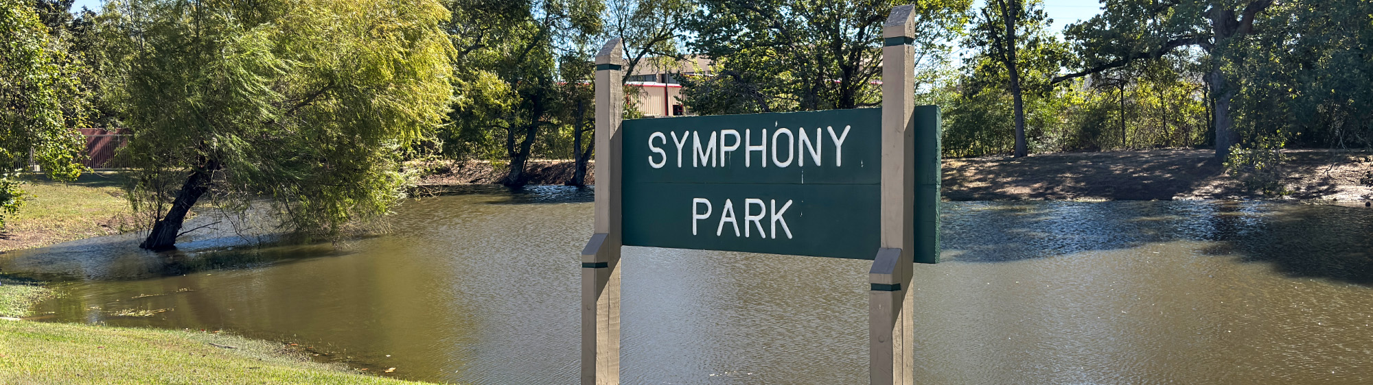 Symphony Park sign and pond.