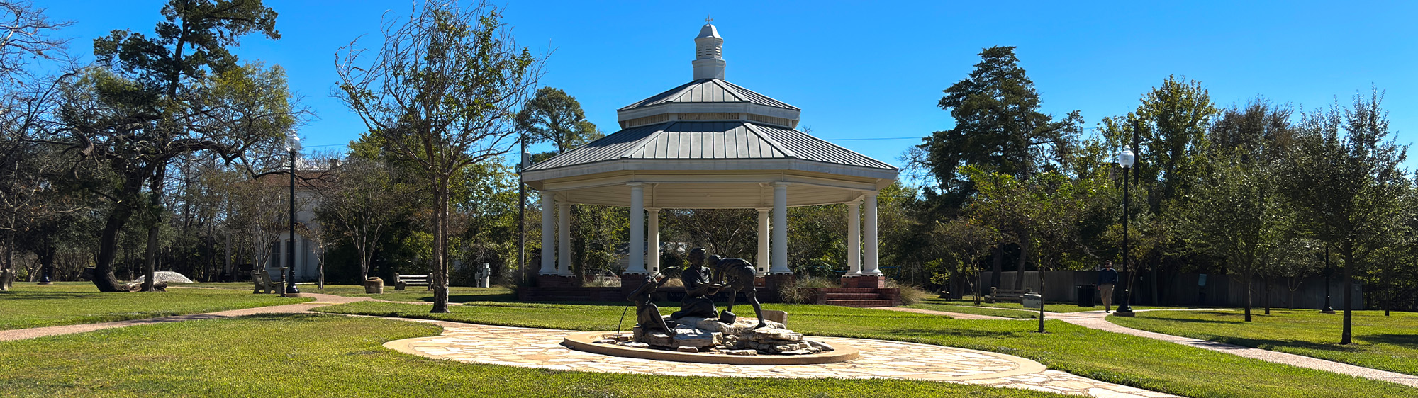 Gazebo and statue at Heritage Park on a sunny day.