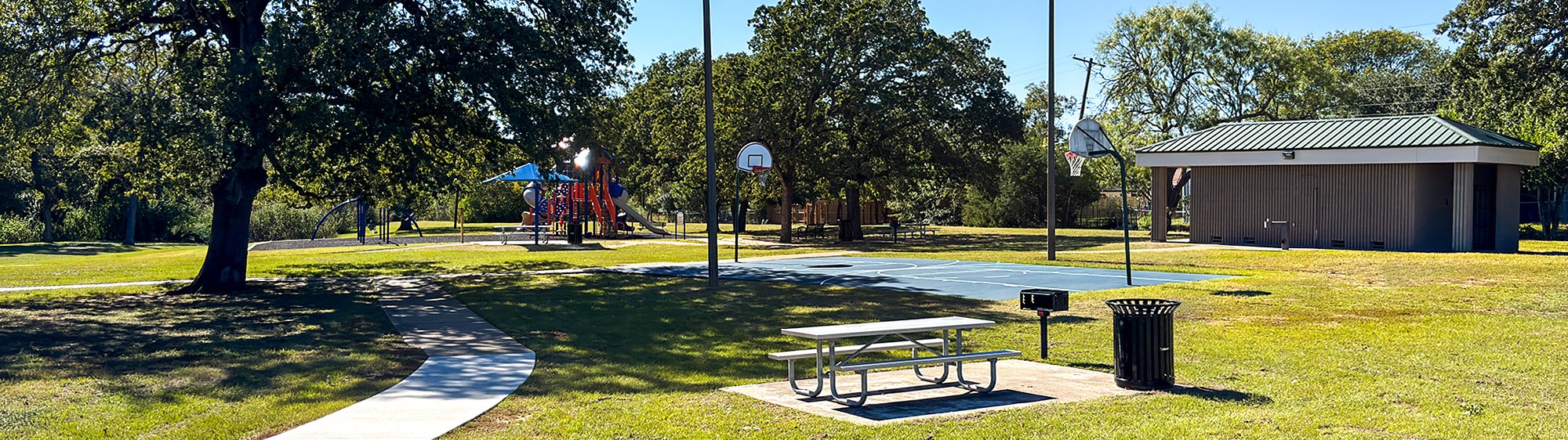 Basketball court, playground, restroom and picnic table at Henderson Park.