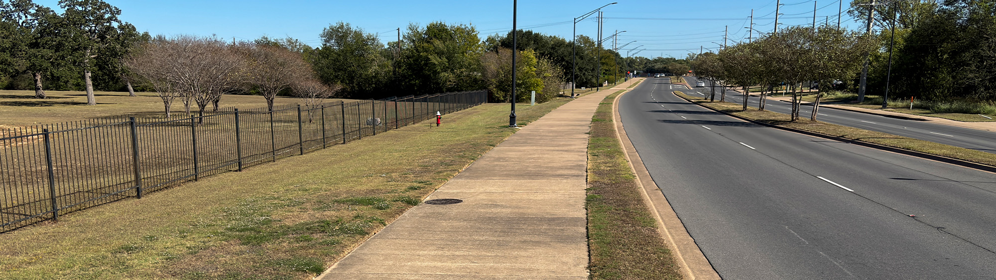 Boonville Trail sidewalk, with Boonville Road on one side and a grassy area on the other.